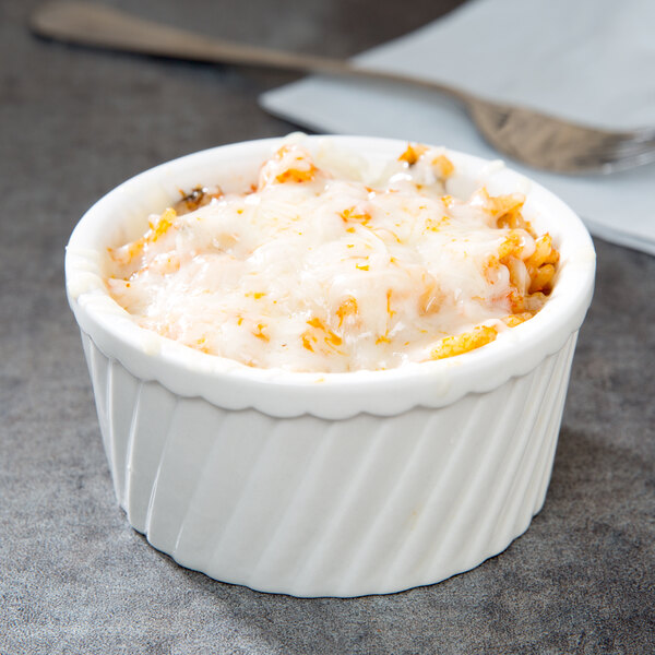 A CAC bone white fluted souffle bowl filled with food.