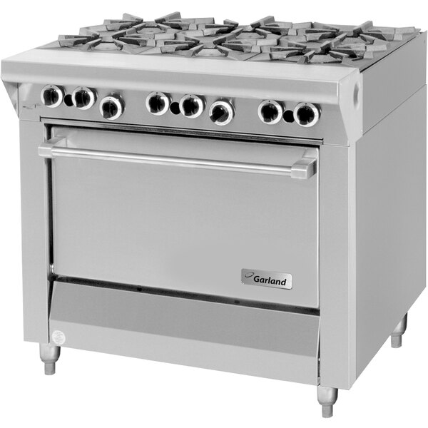 A large stainless steel Garland liquid propane range with six burners and a storage base.