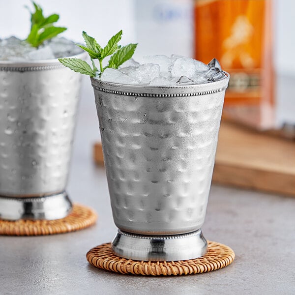 Two silver Acopa Alchemy mint julep cups with ice and mint leaves.