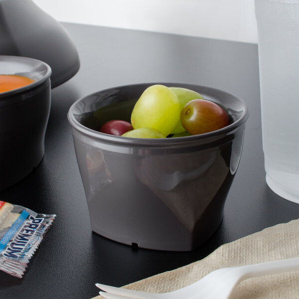 A Cambro Harbor Collection smoked metal insulated plastic bowl filled with green grapes.