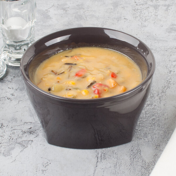 A Cambro insulated plastic bowl of soup with vegetables and rice.