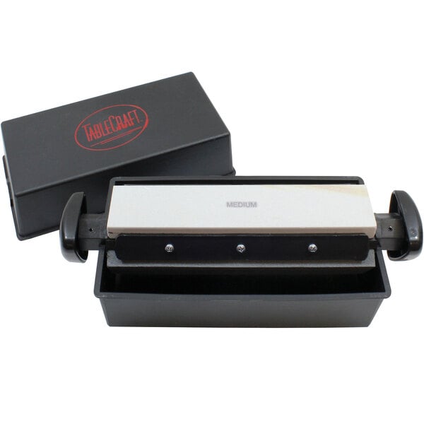 A black Tablecraft 3-way knife sharpening system box with white and black rectangular objects inside.