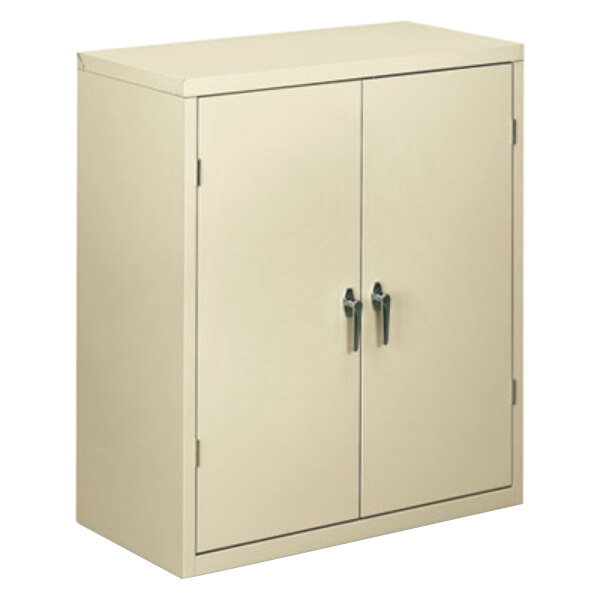 A beige HON storage cabinet with two doors.