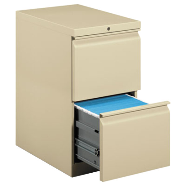 A HON putty filing cabinet with two drawers open.