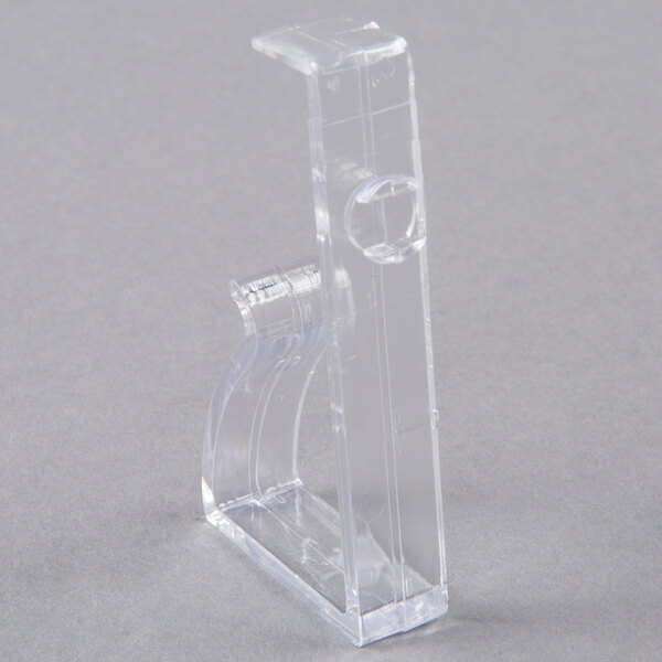 A close-up of a Snap Drape clear plastic table skirt clip.