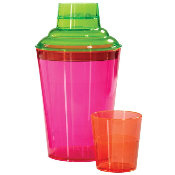 A pink and green GET Cheers cobbler cocktail shaker with a green lid and orange glass.