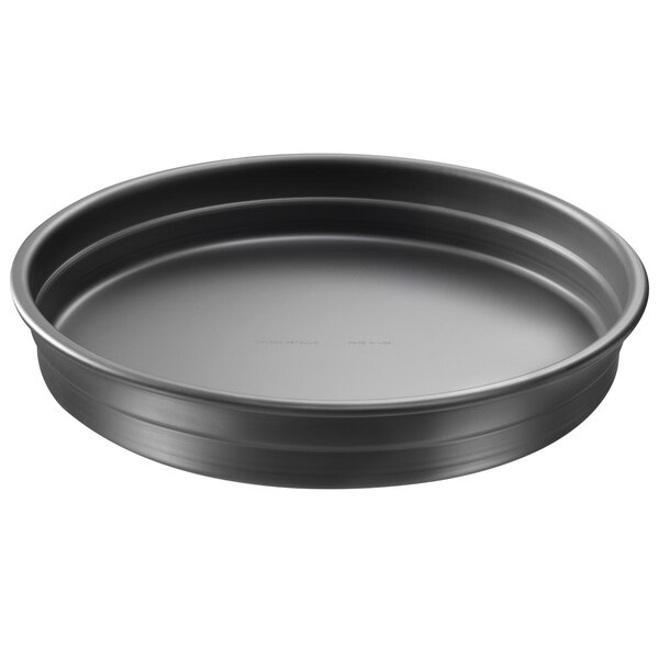 A black round Chicago Metallic deep dish pizza pan with a white background.
