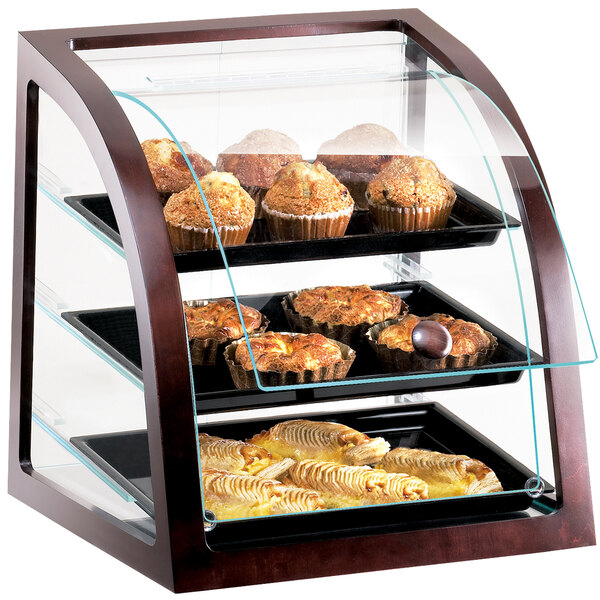 A Cal-Mil Westport bakery display case filled with muffins and pastries.