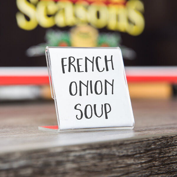 A clear acrylic table card holder with black text that says "French Onion Soup" in it.