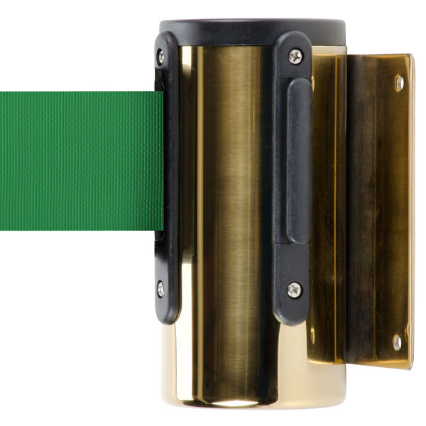 A brass stanchion with a green retractable belt.