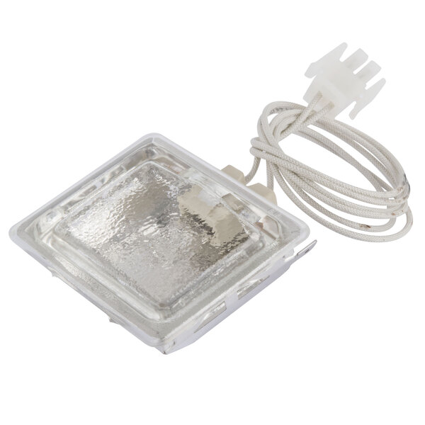 A square glass oven light with a cord.