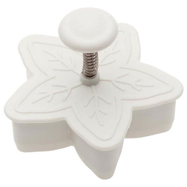 A white plastic snowflake shaped cookie cutter.