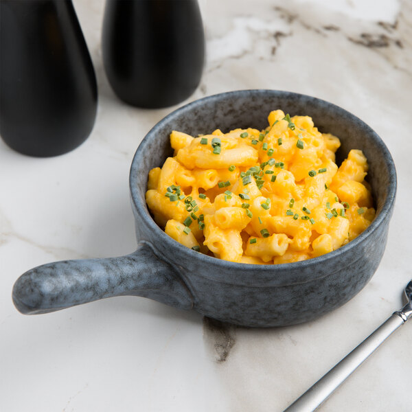 A blue 10 Strawberry Street Biseki stoneware skillet with macaroni and cheese on a table.