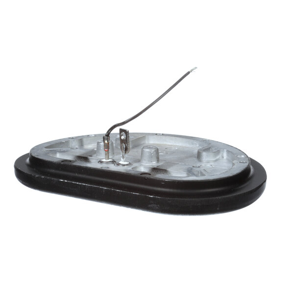 A black and silver oval Vollrath heater with a wire.