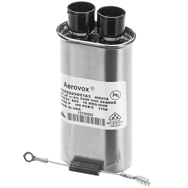 A silver cylindrical capacitor with black and white wires.
