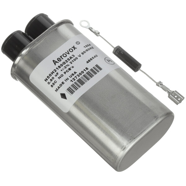 A silver Amana capacitor with black caps and black wires.