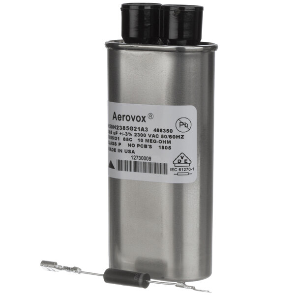 A silver metal capacitor with black and white labels.