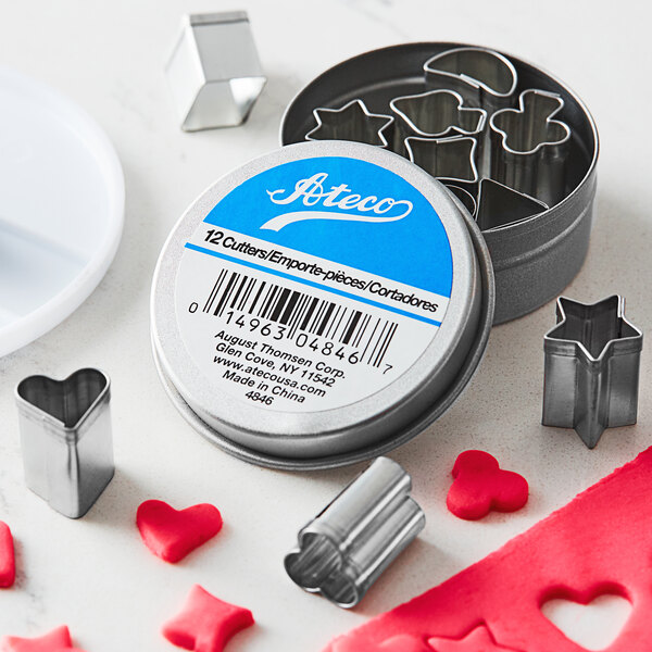 A metal container with Ateco tin heart-shaped cookie cutters.