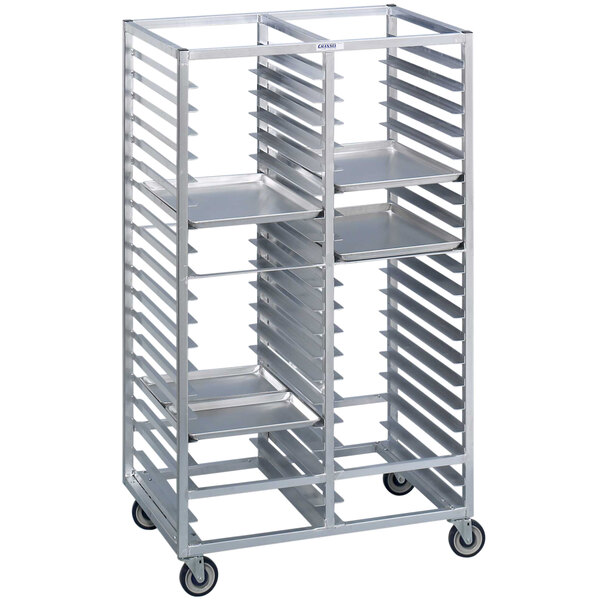 A silver metal Channel tray rack with four shelves on wheels.