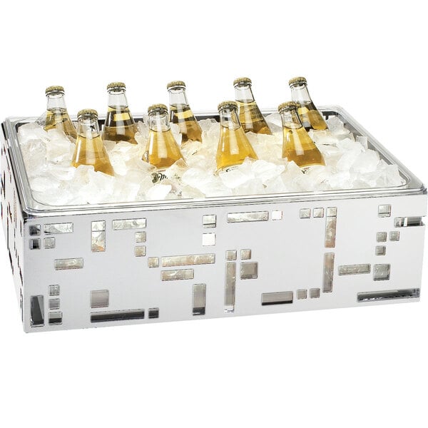 A Cal-Mil stainless steel ice housing with bottles of beer on ice inside.