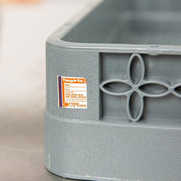 A gray plastic container of Taylor TempRite dishwasher test labels.