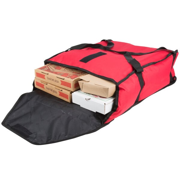 A red San Jamar insulated pizza delivery bag with pizza boxes inside.