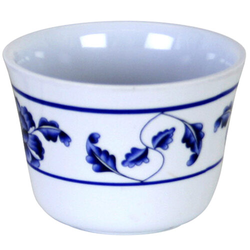 A white melamine tea cup with a blue and white lotus design.
