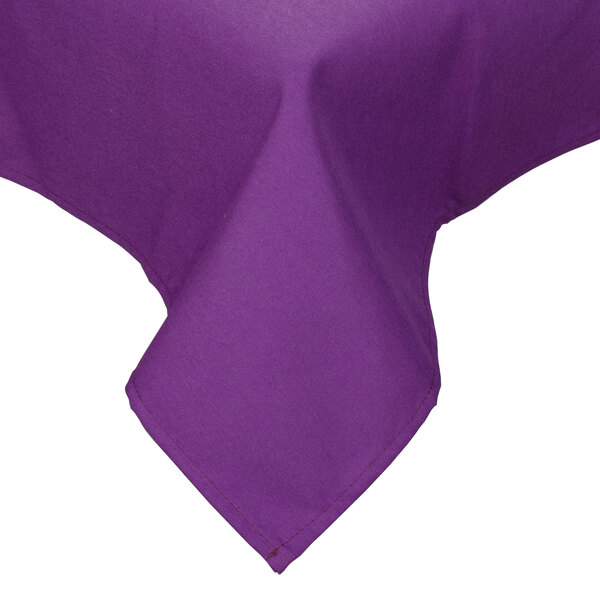 A purple Intedge rectangular table cover with a folded edge on a table.