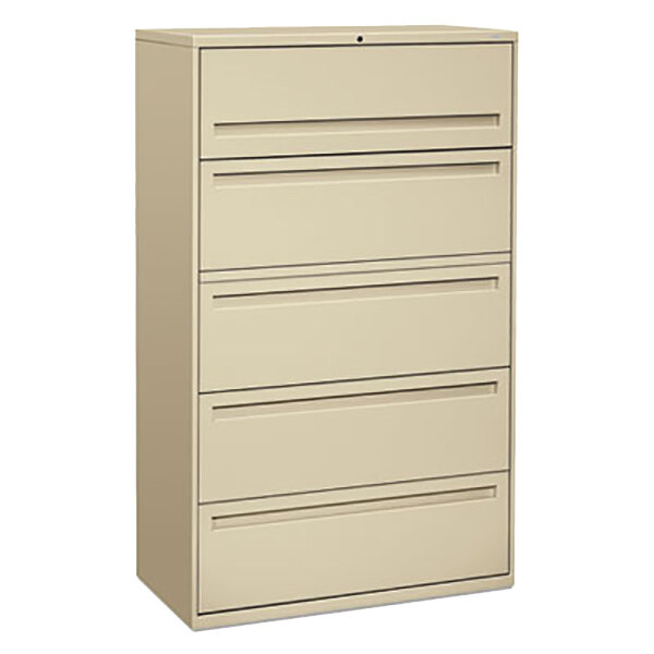 A tan metal filing cabinet with five drawers.