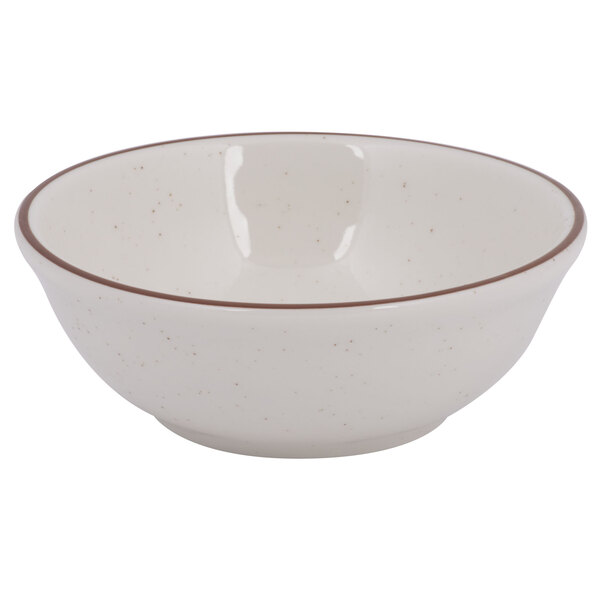 A white bowl with brown speckled rim.