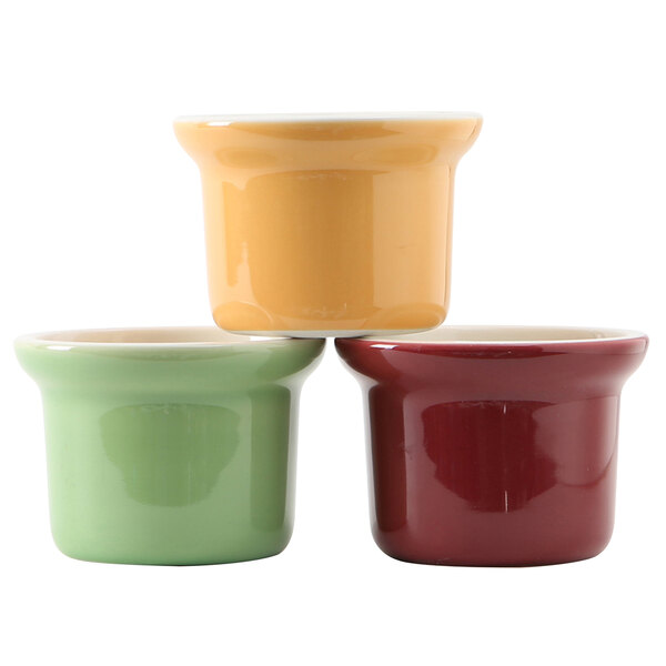 Three small ceramic Tuxton Petite Marmite containers in different colors.