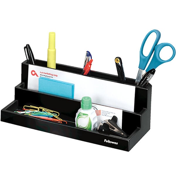 A black Fellowes desktop organizer with 7 sections holding stationery items.