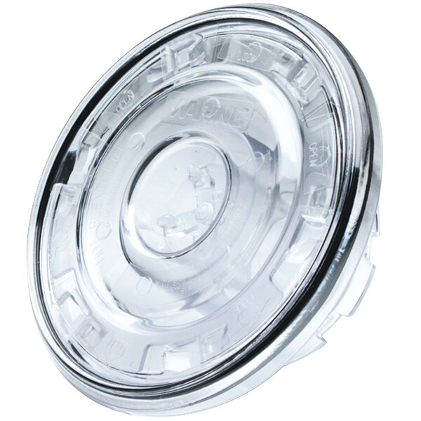 A clear plastic lid with a ring and a hole.