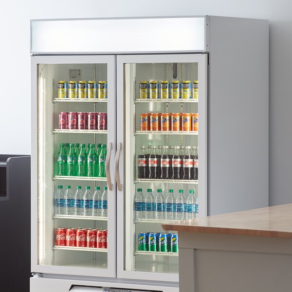 A white Beverage-Air refrigerated glass door merchandiser full of drinks and beverages.