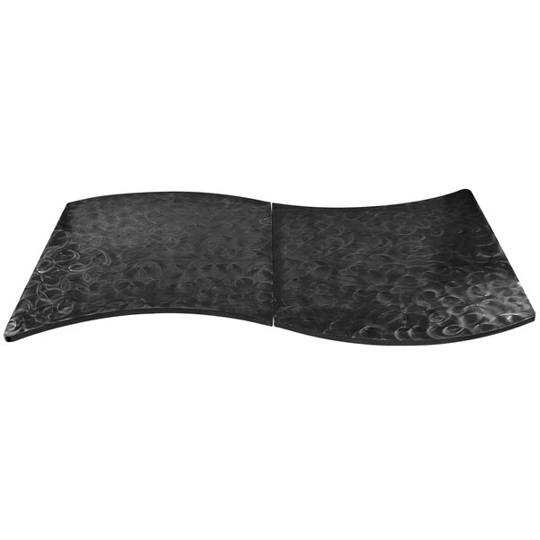 A black metal serpentine swirl table cover with a curved design.