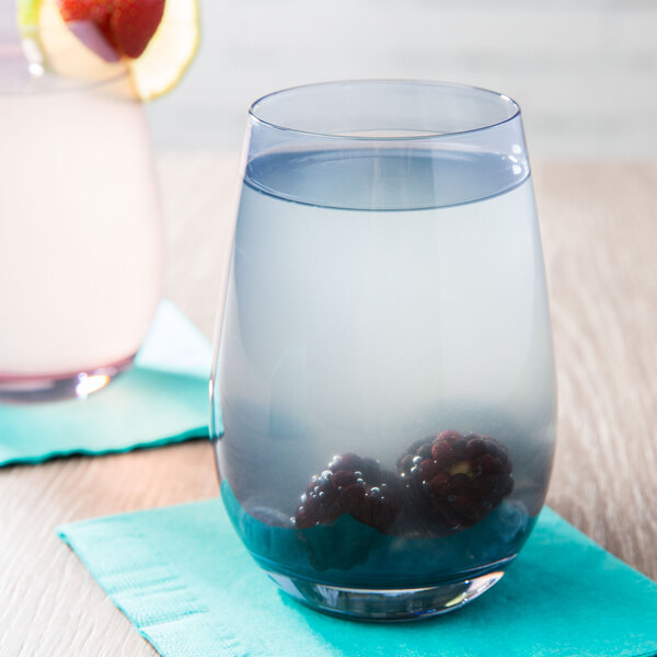 A Stolzle stemless wine glass filled with water and berries on a white background.