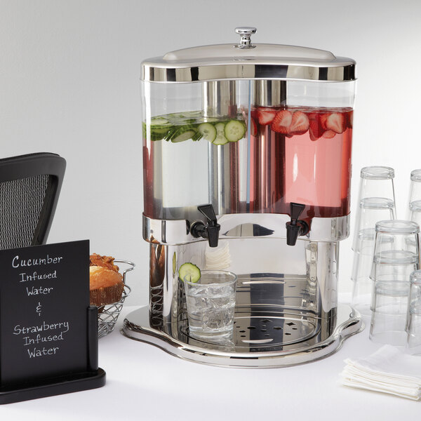 An American Metalcraft dual beverage server with glasses of water and a drink dispenser.