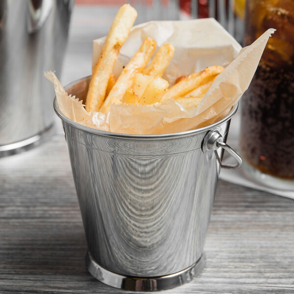 A Clipper Mill stainless steel mini serving pail filled with french fries and a drink.