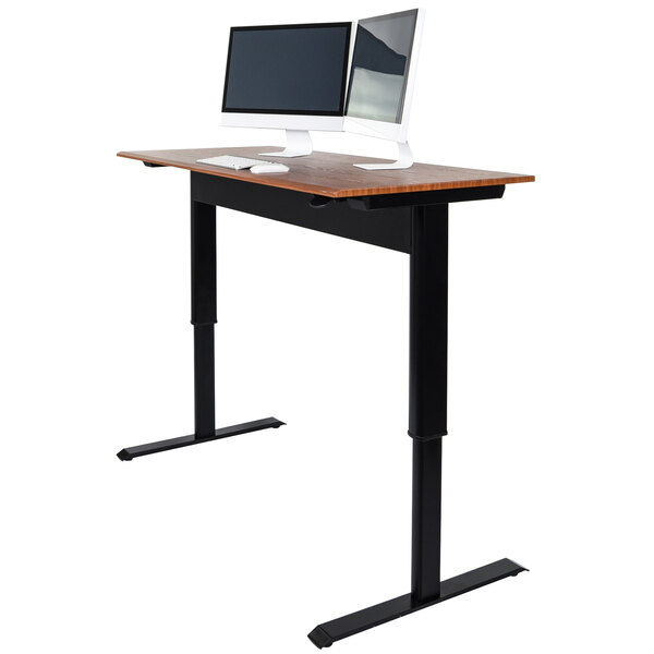 A Luxor stand up desk with a computer and two monitors on it.