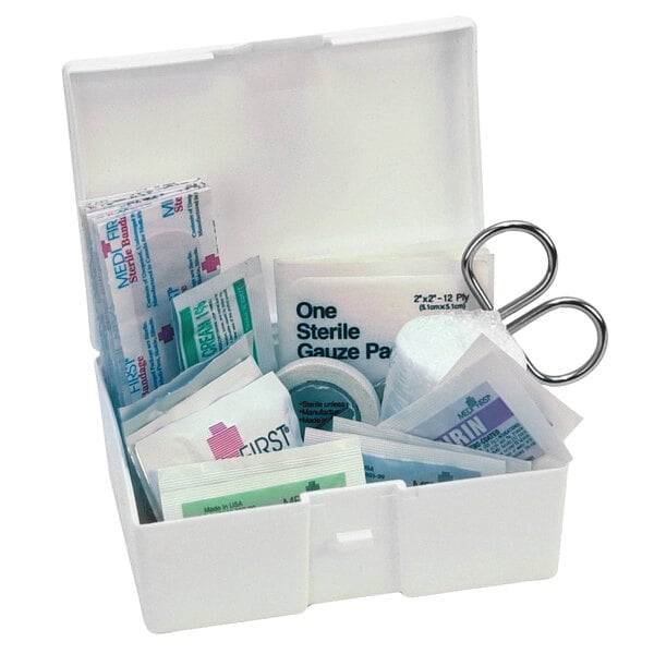 A white Medique first aid kit with scissors and bandages.