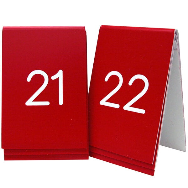A red Cal-Mil table number sign with white numbers reading 21 and 22.