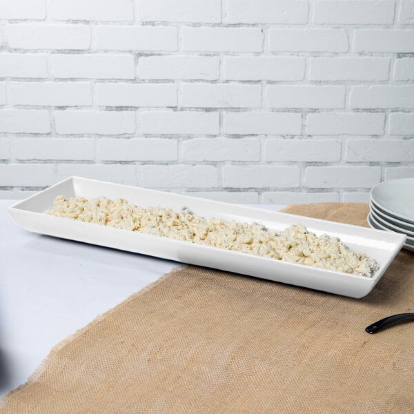 A white rectangular Tablecraft tray with food in it.