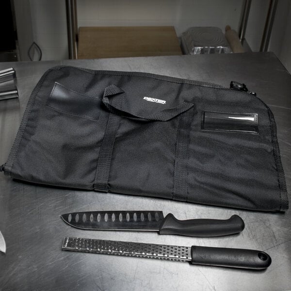A black Dexter-Russell cutlery case on a table with a knife inside.