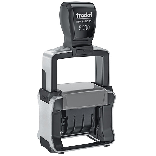 A black and grey Trodat self-inking professional date stamp.