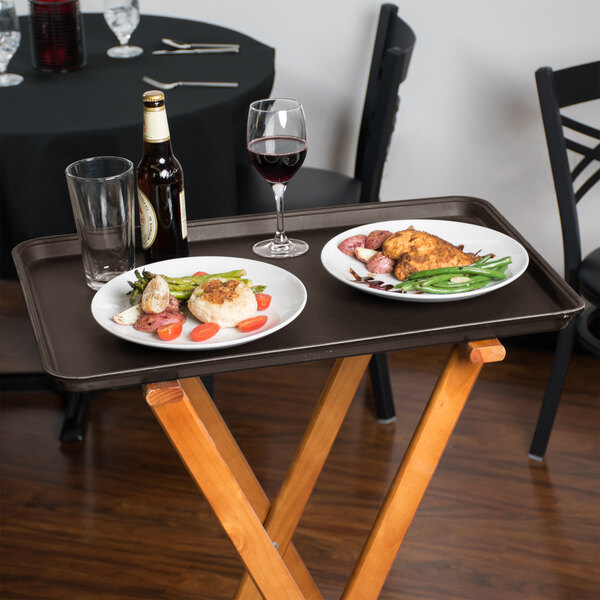 A Tavern Tan non-skid tray with plates of food and a glass of red wine on a table