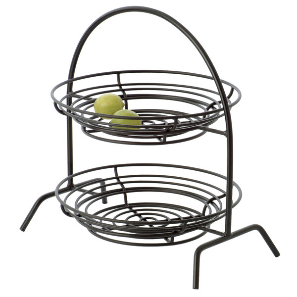 A black metal 3-tiered riser with round fruit on it.