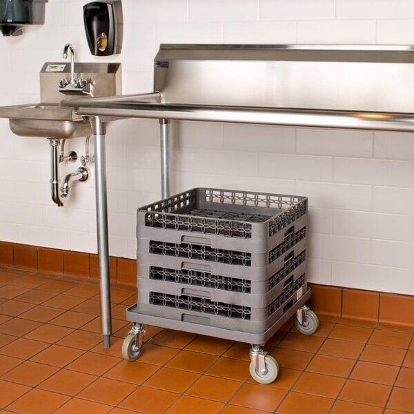 A grey Noble Products dish rack and glass rack dolly under a sink in a kitchen.