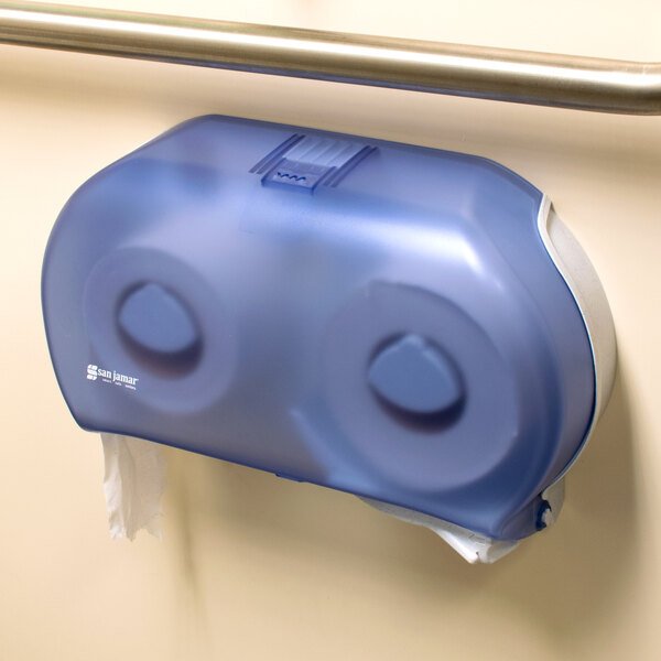 A blue San Jamar Twin Classic double roll toilet paper dispenser on a wall.