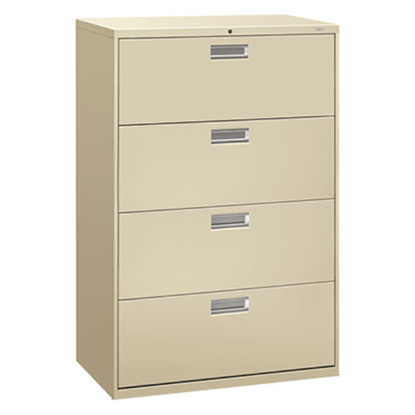 A tan filing cabinet with silver handles and four drawers.