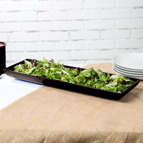 A Tablecraft Midnight Speckle cast aluminum rectangular tray with a salad on a table.